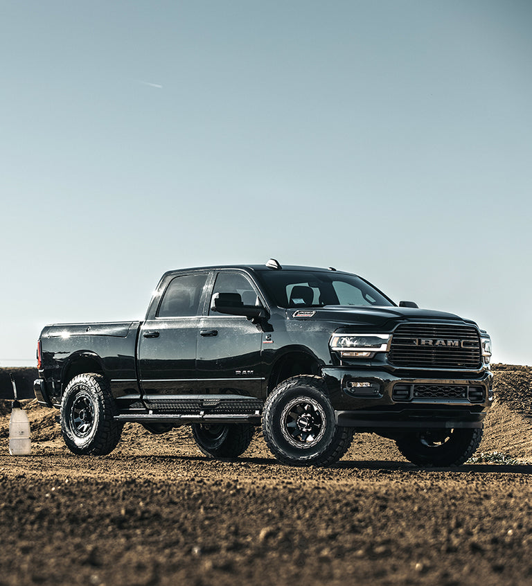 Loading a dirt bike into a RAM 1500 truck bed offroad on Method Race Wheels 317 Standard wheels.