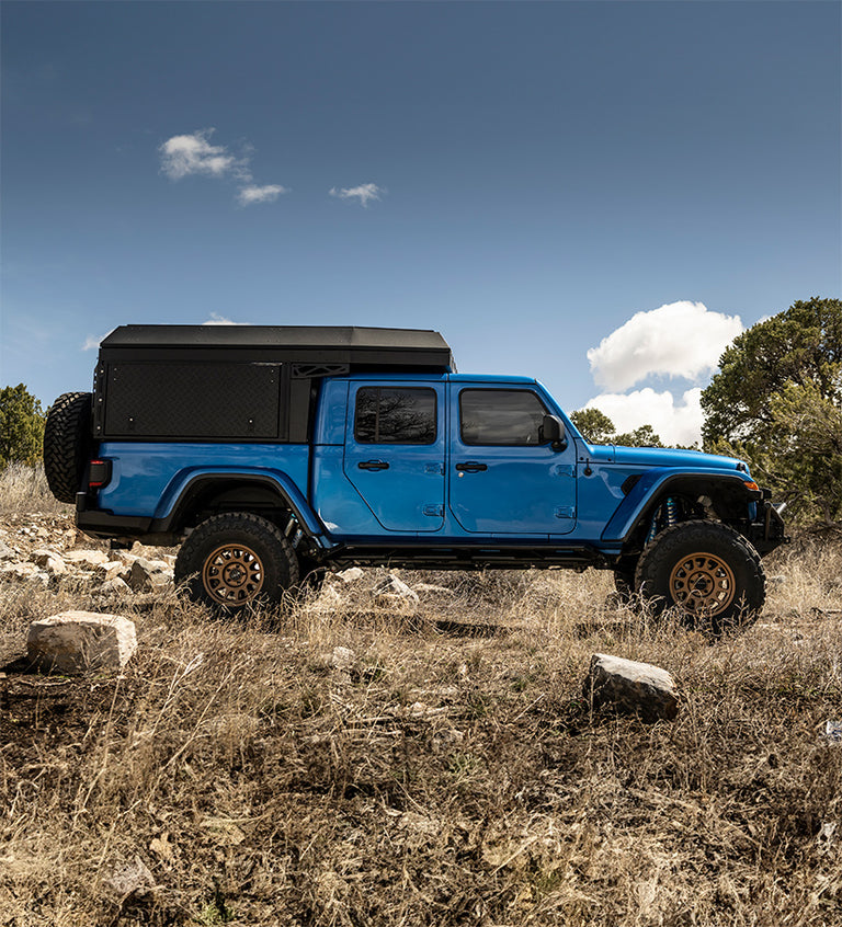 Jeep Gladiator offroad on Method Race Wheels 703 Bead Grip wheels in a bronze finish.